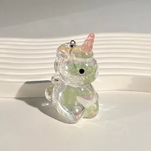 Macro detail of iridescent unicorn charm with colorful aurora finish and metal ring