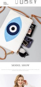Detailansicht der gewebten Canvas-Clutch mit Evil Eye Stickerei und geräumigem Innenraum