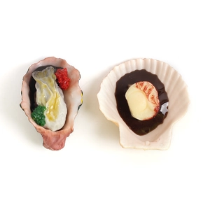 Realistic artificial grilled oyster and scallop food models on white background