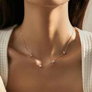 Elegant rose gold S925 sterling silver MAMA letter necklace worn on woman's neck