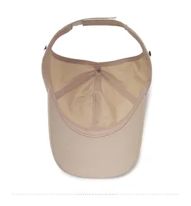 Detail view of the beige sun visor hat inner lining, stitching, and adjustable velcro strap