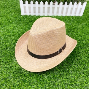 Detail of straw hat weave texture with dark brown leather strap and silver buckle