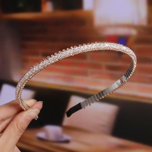 Detail showing hand-held champagne crystal headband with sparkling silver metal frame