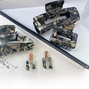 Detailed set of premium marbled acetate hair claws and clips in black and grey tones