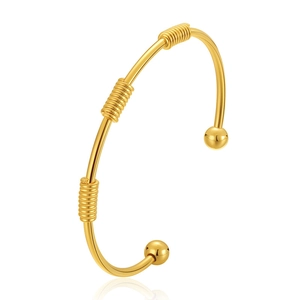Polished 18K gold-plated brass open cuff bracelet featuring spiral wire and bead details