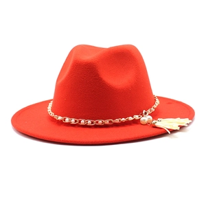 Detail view of red wool jazz hat with gold chain, white pearls and tassel accent