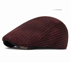 Detail of burgundy tie-dye beret showing vertical knit texture and black brim piping