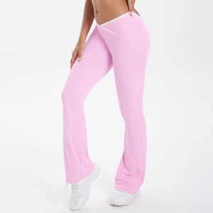 Detail showing high waist white V-cross waistband design on pink yoga flare pants