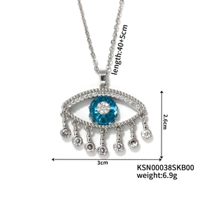 Detailed view of evil eye pendant with blue zircon stones and tassel showing dimensions