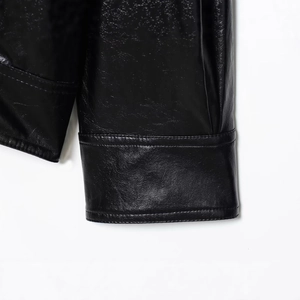 Women's black faux leather bomber jacket featuring textured material and ribbed cuffs