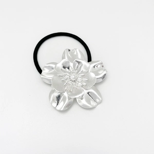 Macro shot of silver flower headpiece with high-elastic black hair tie band