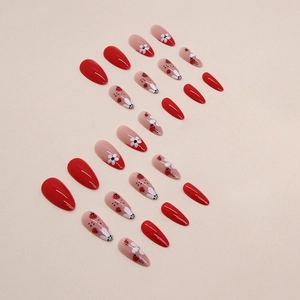 Almond-shaped press-on nails with red ladybug motifs and white daisy floral patterns