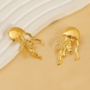 Detailed view of jellyfish-shaped gold stud earrings with a glossy mirror-like finish