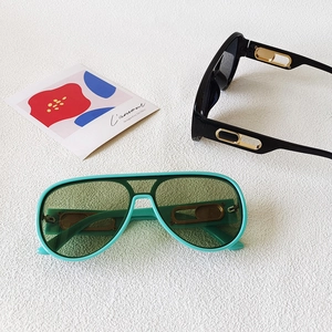 Oversized aviator sunglasses with gold hollow metal temple accents in black and mint green