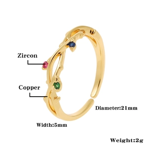 Detailed view of vine-shaped copper ring with red blue and green zircon stones