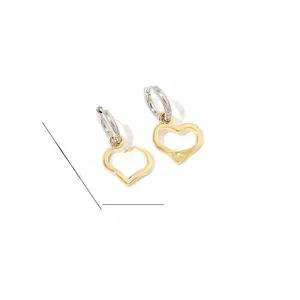 Detailed view of gold heart earrings showing dimensions 2.9cm by 1.7cm and polished finish