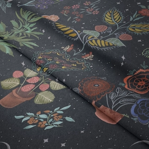 Close-up of bohemian floral fabric texture with strawberry and moon phase print details
