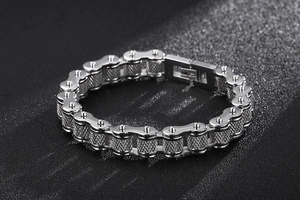 Detailed close-up of a men's vintage silver bike chain bracelet with a textured box clasp