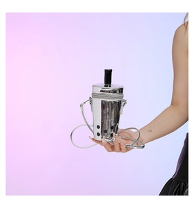 Detail of silver metallic milk tea cup bag with straw feature and cross-body strap