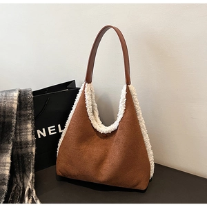 Detail of brown hobo bag featuring plush white faux fur trim and premium suede texture