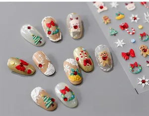 Macro shot of 5D Christmas nail stickers with 3D embossed reindeer and snowflake details