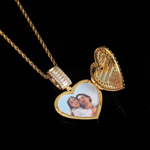 Detailed view of an open golden heart locket with couple photo and pavé zirconia stones