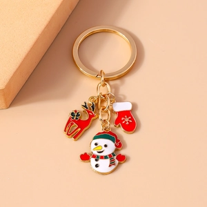 Detail of Christmas keychain with enamel charms of a snowman, reindeer, and glove motifs