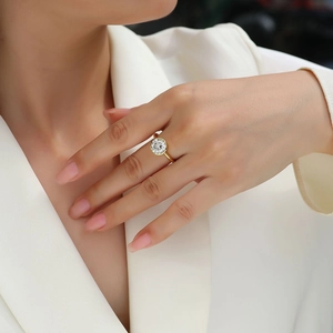 Close-up of a gold-plated S925 silver ring with a round moissanite on a model's hand