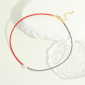Detail of colorful MGB glass beads necklace with irregular freshwater pearl pendant