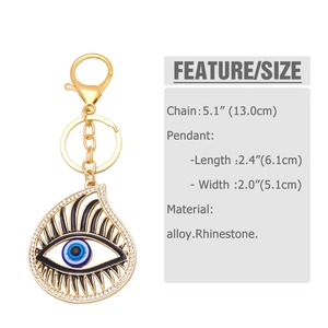 Detail showing dimensions of the gold evil eye keychain with white rhinestones