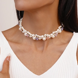 Detail of double-layer choker with faux pearls and pink gemstone heart pendant