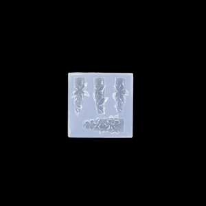Macro shot of 3D lily and cherry blossom relief patterns in translucent silicone mold