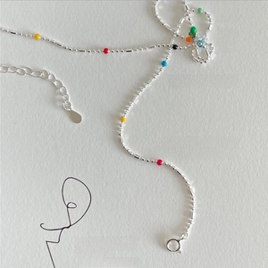 Detailed shot of 925 sterling silver chain with vibrant colorful beads and a lobster clasp