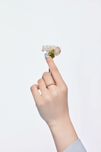Detail of s925 silver ring featuring vibrant colorful zircon stones on model's finger