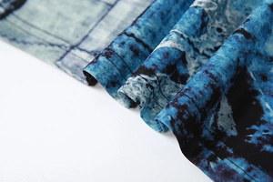 Macro detail of high-quality fabric showing blue and black irregular textures and fine stitching