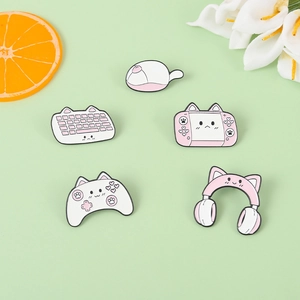 Close-up of pink gaming cat enamel pins set featuring a keyboard, mouse, and game console