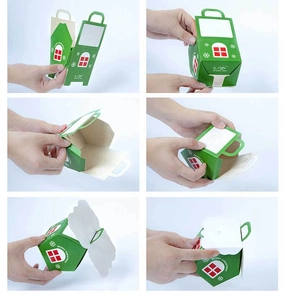 Step-by-step assembly of a green house-shaped Christmas candy gift box with a handle
