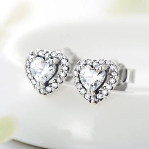 Sparkling sterling silver heart stud earrings with cubic zirconia halo in a macro view