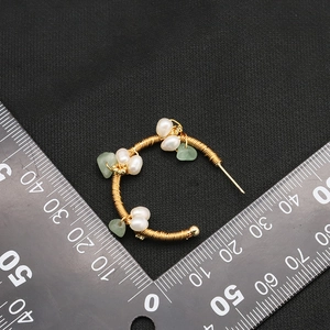 Handmade golden wire-wrapped C-shape earrings with white pearls and green gemstones