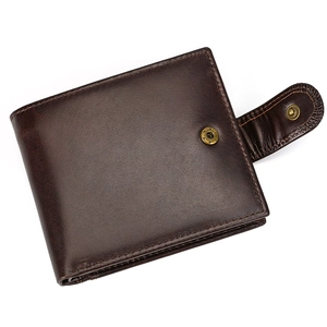 Macro shot of dark brown genuine leather trifold wallet with metallic snap closure and stitching