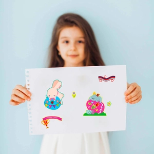 Girl holding paper with colorful Easter bunny stickers and Happy Easter lettering