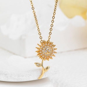 Elegant gold sunflower pendant necklace with sparkling white zircons on a delicate chain