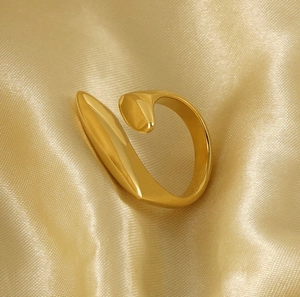 Detail of minimalist 18k gold plated stainless steel open ring on silk fabric