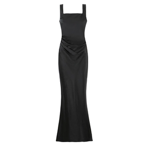 Detailed view of black satin evening gown featuring pleated waist and square neckline