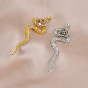 Detailed macro view of gold and silver snake brooches with realistic scale texture
