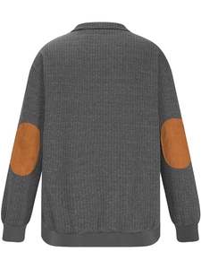 Detail of grey waffle knit fabric with brown oval elbow patches on a men's sweatshirt