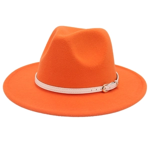 Detailed close-up of orange wool fedora hat with white belt strap and gold buckle