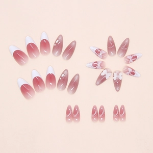 Detail of pink cat-eye press-on nails with 3D white bows and French tip design