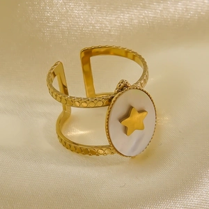 Macro detail of gold-plated stainless steel ring with shell inlay and star motif