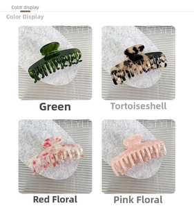 Detail view of acetate hair claws in green, tortoiseshell, red floral and pink patterns